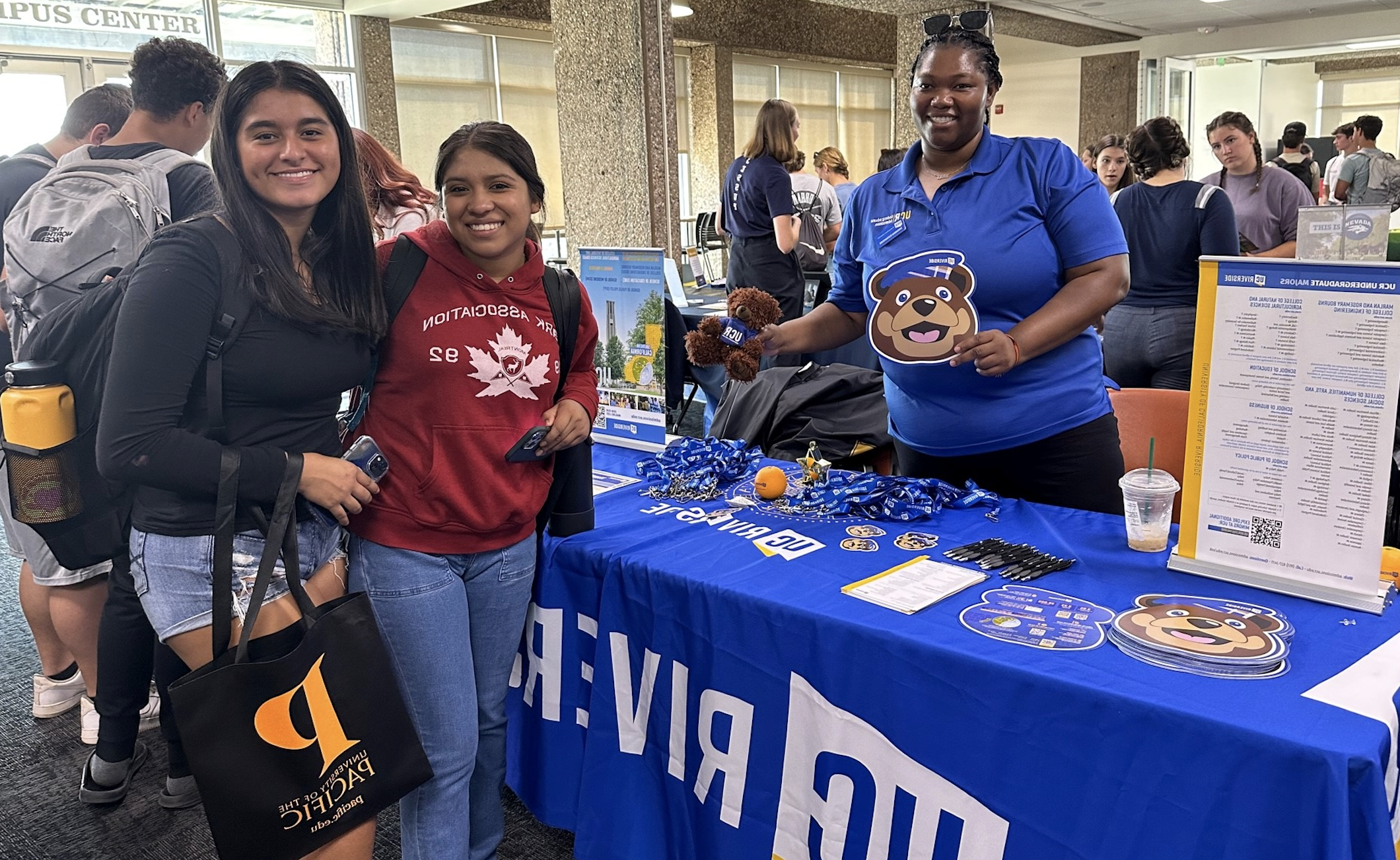 Two high school students are shown visiting UC Riverside's information booth during Transfer Day 